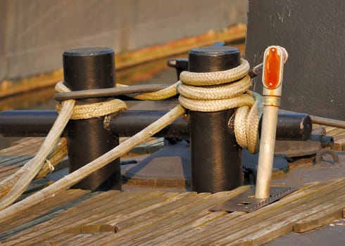 A ship tied down at a boat dock.