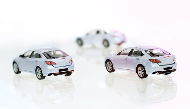 Three model's of car on glass material