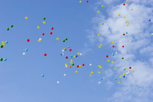 many multicolored balloons flying in blue sky