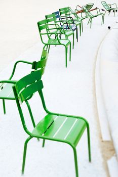 Parisian metallic chairs in the city park. Photo with tilt-shift lens
