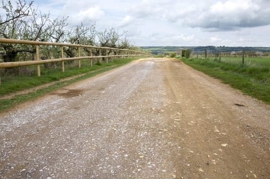 A road in the countryside with a wooden fence