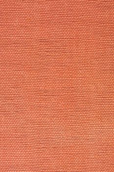 orange, coarse textile background from a vintage 1960s book cover