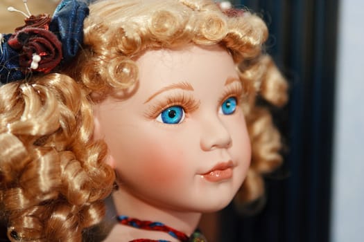 A close up of a young innocent doll face