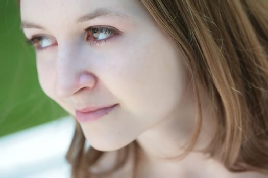 close-up romantic portrait of the green-eyed girl with long hair