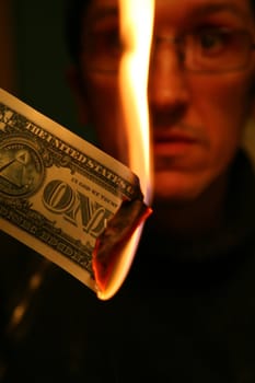 Dollar in Fire on Background of the Alarmed Person