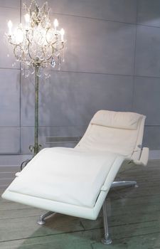 candelabrum and white leather easy chair with armrest for relaxation