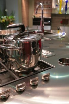 fragment of modern kitchen with gas fryer and saucepan