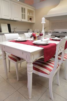 modern kitchen with white furniture in classical style and with served table