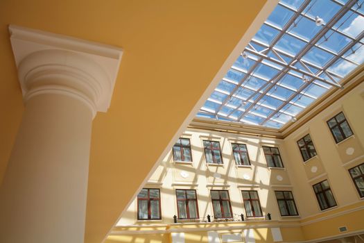 abstraction, interior of the building in classical style with pillar and glass ceiling