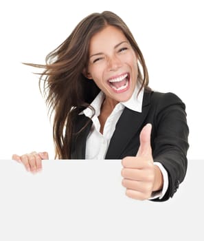Excited woman thumbs up with blank poster sign. Young businesswoman mixed asian caucasian ethnicity.
