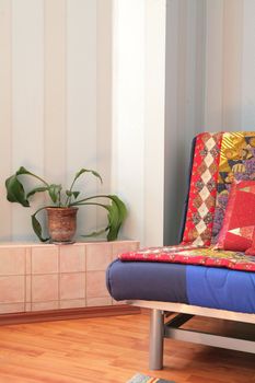 fragment of the interior of the apartment with room plant in clay pot