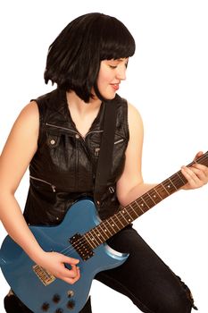 Young woman plays on a electric guitar, isolated