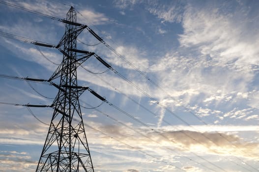Low angle perspective shot of electric tower with at dusk.