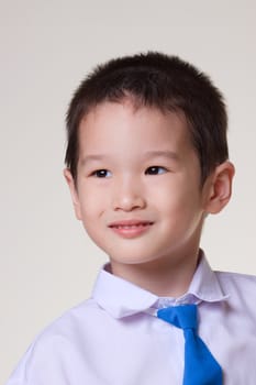 Young Asian Boy portrait wearing a white shirt and blue tie
