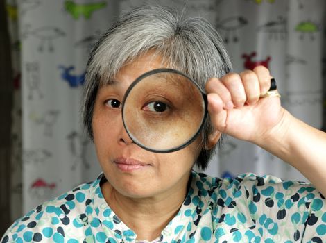 woman holding magnifier