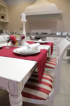 modern kitchen with white furniture in classical style and with served table