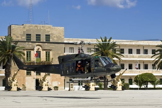 MALTA - OCTOBER 05 2008 - Military Huey UH1-N helicopter landing at Luqa Barracks