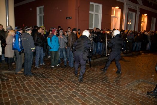 Agresive crowd and police near Latvian Parliament. Riga, Latvia, January 13, 2009