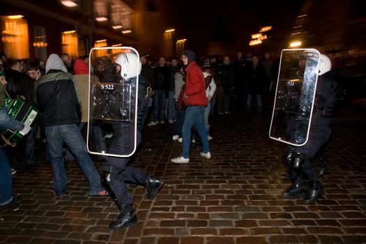 Agresive crowd and police near Latvian Parliament. Riga, Latvia, January 13, 2009