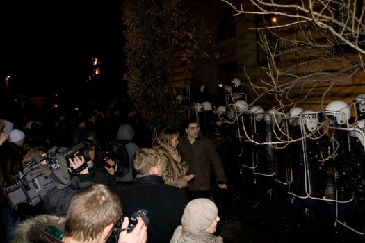 Agresive crowd and police near Latvian Parliament. Riga, Latvia, January 13, 2009