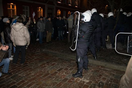 Agresive crowd and police near Latvian Parliament. Riga, Latvia, January 13, 2009