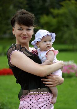 Happy mum and her child in park