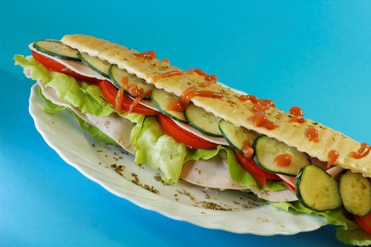 chicken breast sandwich with lettuce, tomatoes and cucumbers