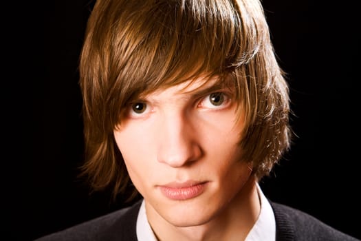 Young serious man over black background