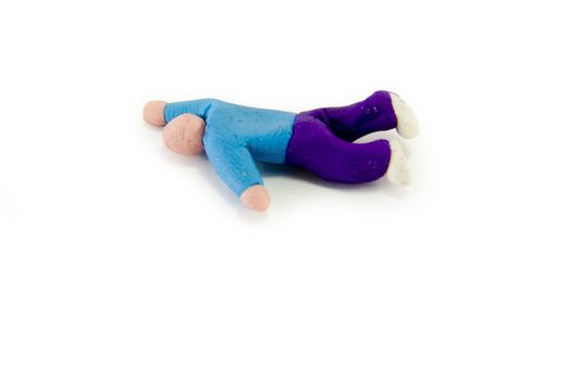Plasticine man lying down, symbolic of death