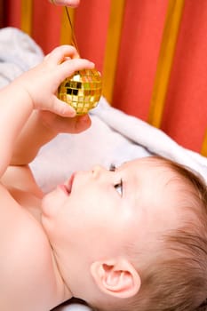 Adorable Seven month Baby girl playing with xmas decoration