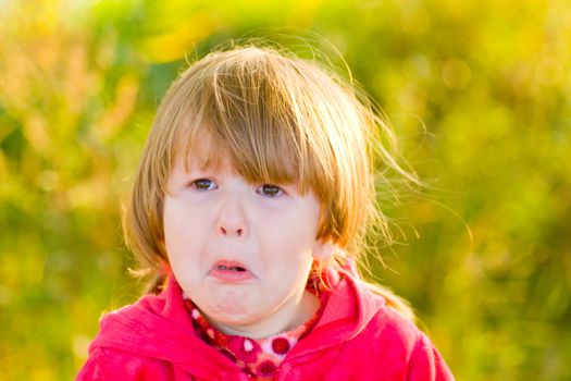 Crying 4 years girl looking away outdoors