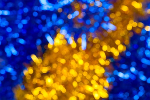 Abstract christmas background made from yellow and blue tinsel