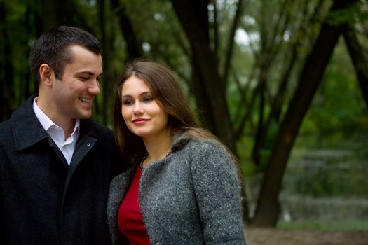 Two young lovers enjoying each other in park