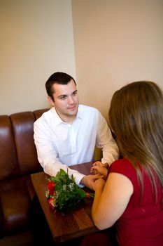 Date in Cafe two young lovers sitting at table