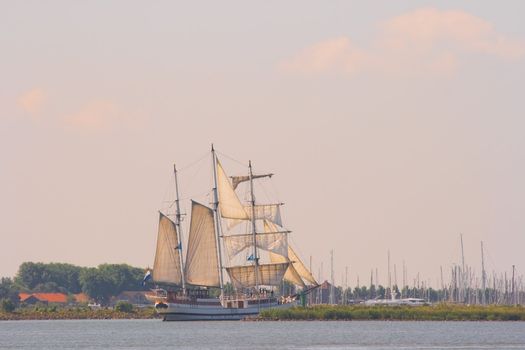 Old ship sailing out in the early morning light