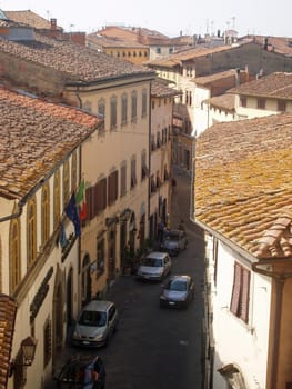 Rooftops and street with sunlight and shade in Tuscany Italy