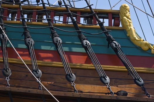 Part of old sailingship with ropes and woodcarvings