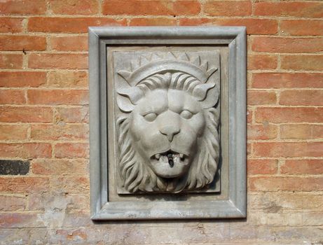 Lionshead fountain with brick wall background