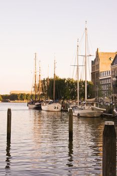 Small harbour in Rotterdam with old sailingships in evening light
