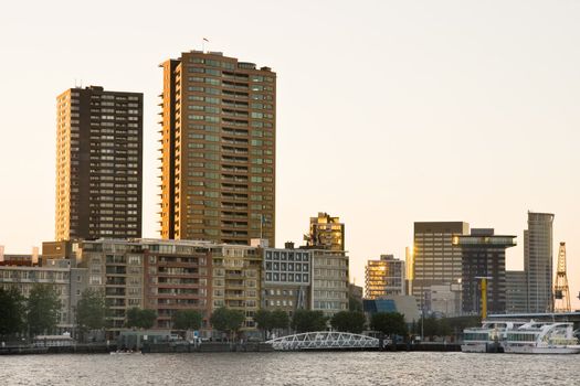 Residential buildings in Rotterdam at the riverside by late evening light