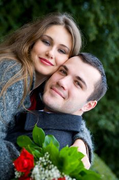 Two young lovers enjoying each other in park