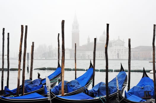 Venice gondolas in fog with grand canal in background