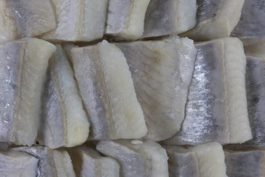 sliced pickled herring prepared in wine sauce, macro shot