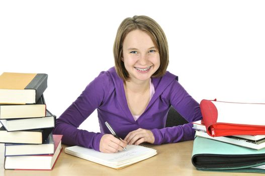 Happy teenage girl studying at the desk