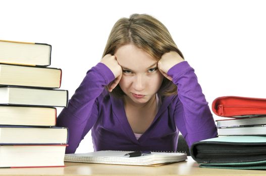 Unhappy teenage girl studying at the desk