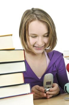 Teenage girl text messaging with cell phone in school