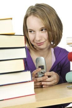 Teenage girl text messaging with cell phone in school