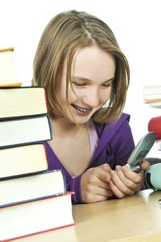 Teenage girl text messaging with cell phone in school