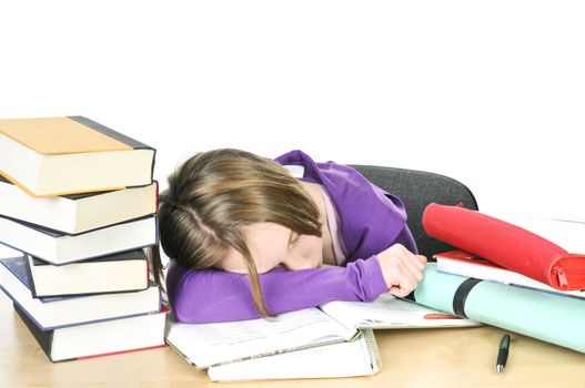 Teenage girl studying at the desk being tired