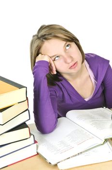 Unhappy teenage girl studying at the desk